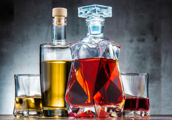 Carafe and bottles of assorted alcoholic beverages.