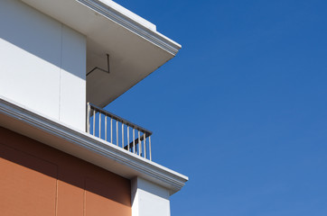 modern office building with blue sky and clouds