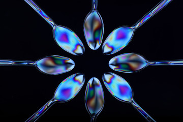 Polarised plastic spoons arranged on multi-plane