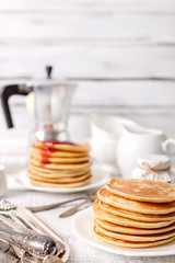 Tasty breakfast. Pancakes with strawberry confiture and butter.