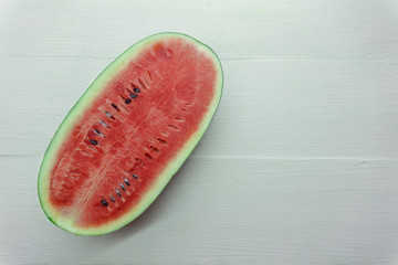 Plakat Close Up over head of fresh watermelon fruit cut slice red Dissect isolated on wood table white background