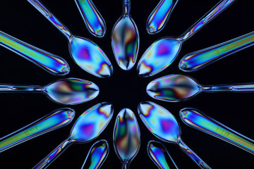 Polarised plastic spoons arranged on multi-plane