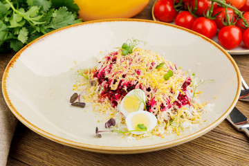 a plate with herring under a fur coat. kitchen concept