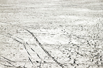 White snow background with traces of people and skis