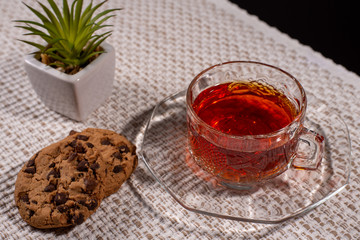 black tea in a glass cup and biscuits 