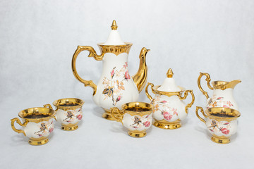 White and gold ceramic tea set