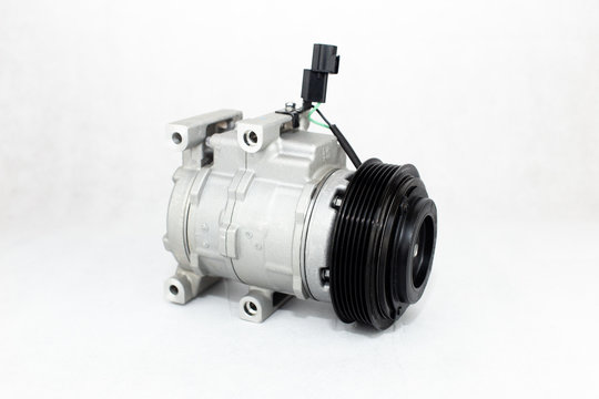 New car air conditioning compressor on white background