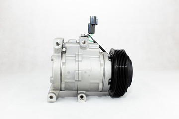 New car air conditioning compressor on white background