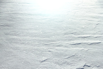Blue white abstract sunny snow sparkling background with traces of wind