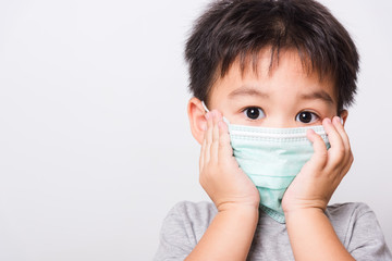 Closeup Asian face, Little children boy sick he using medicine healthcare mask
