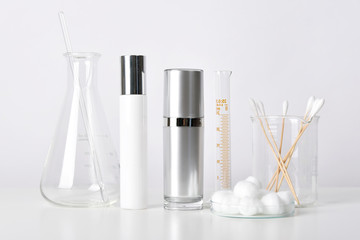 Cosmetic bottle containers and scientific glassware, Blank package for branding mock-up, Pharmaceutical skincare by dermatologist doctor, Research and develop beauty product concept.