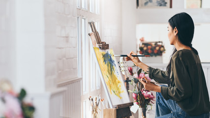 Woman Artist Works on Abstract acrylic painting in the art studio. - obrazy, fototapety, plakaty