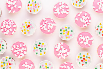 Colorful cupcakes on a white background.