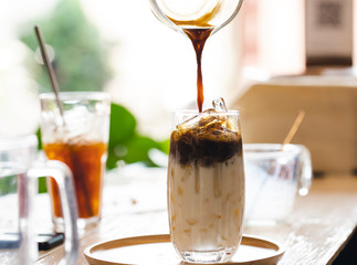 Pouring coffee on a glass