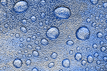 Drops on the skin. Artificial leather. Close-up of water drops. Abstract blue wet texture with drops on the surface. Realistic clean water drops. Classic blue
