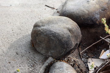 Large stones from the river bank folded in barbecue with an iron mesh for heating people at night.