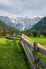 Fototapeta na wymiar Wooden fence with bench in Zgornje Jezersko, Kamnik-Savinja Alps