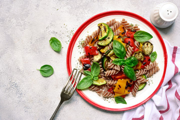 Whole grain pasta with grilled vegetables. Top view with copy space.