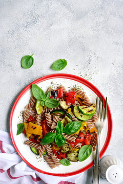 Whole grain pasta with grilled vegetables. Top view with copy space.