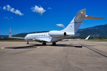 Fototapeta na wymiar Beautiful private business jet Gulfstream G5 on the tarmac of Figari airport. Super rich lifestyle during summertime.
