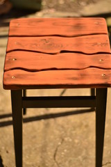Black-brown wood kitchen stool with an electric jigsaw