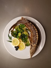 image of sturgeon on a plate with herbs and vegetables