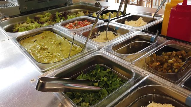 Various fillings for tacos and burritos in restraurant kitchen