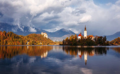 Fototapeta na wymiar Wonderful Nature landscape. Great view of Famouse Bled Lake in summer day. Amazing Sunny Scenery with fairy tale lake during sunset. Julian Alps. Slovenia. Popular Travel destinations