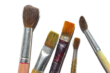 old paint brushes on a white background.