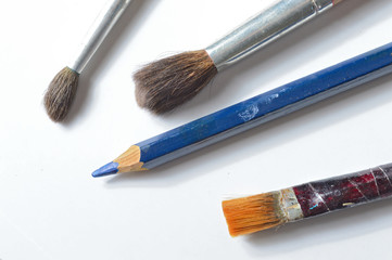 old paint brushes on a white background.