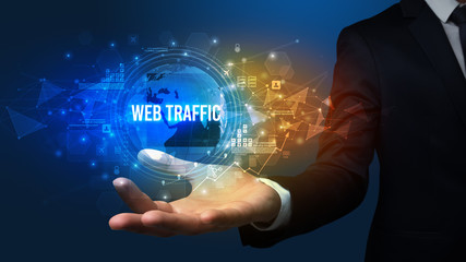 Elegant hand holding WEB TRAFFIC inscription, digital technology concept
