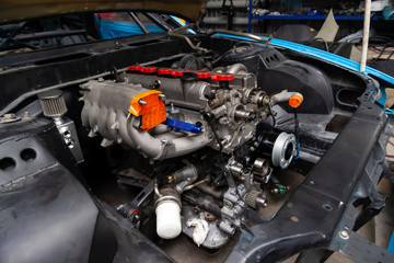 Powerful tuned gasoline engine with a turbocharger and a charger in the engine compartment of the...