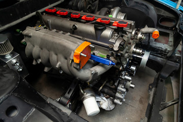 Powerful tuned gasoline engine with a turbocharger and a charger in the engine compartment of the...