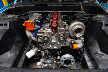 Powerful tuned gasoline engine with a turbocharger and a charger in the engine compartment of an...