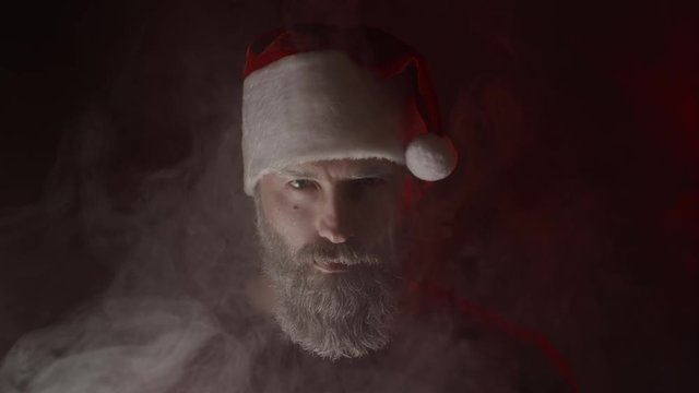 Concept of bad Santa Claus making expressions on black background, slow motion