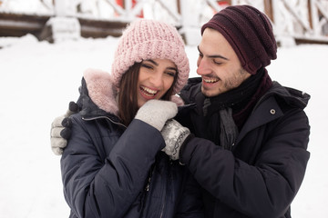Young couple hugging in the Park in winter.