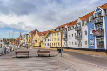 Fototapeta na wymiar Benches at the wooden jetty in the harbor of Sonderborg, Denmark