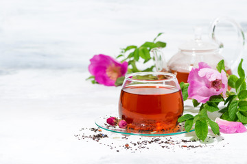 fragrant tea with wild rose in a glass cup