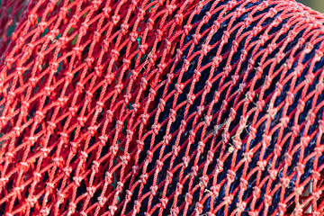 Close-ups of colorful nylon fishing nets drying in the afternoon sun, suitable as backgrounds or textures.