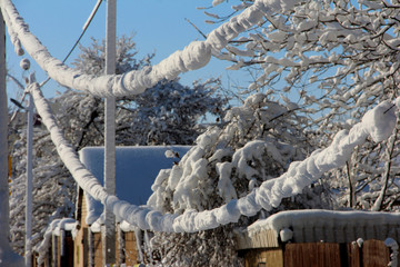 Winter wires. Snow-covered power grids.