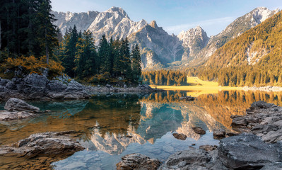 Awesome alpine highlands in sunny day. Scenic image of fairy-tale lake during sunrise. Majestic...