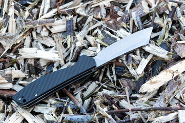 Pocket knife with a carbon handle. Knife handle with a pattern. Top of the knife.