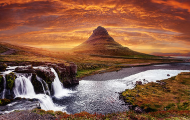 Incredible Nature landscape of Iceland. Colorful sunrise landscape view on Kirkjufellsfoss waterfall. Amazing morning scene near Kirkjufell volkano, Iceland, Europe. the most famous icelandic landmark