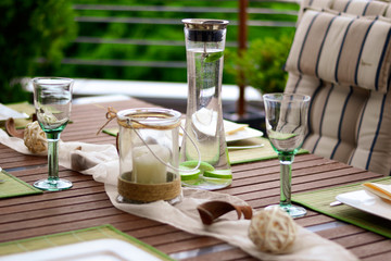 table setting for garden party with bottle of water and decoration