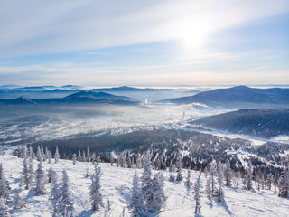 Fototapeta na wymiar Sheregesh Kemerovo region ski resort in winter, landscape on mountain and hotels, aerial top view