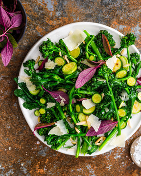 Broccoli salad with fresh leaves, basil, zucchini, almonds and Parmesan cheese