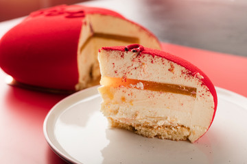 slice of tasty mousse cake on a plate, close-up. holiday dessert