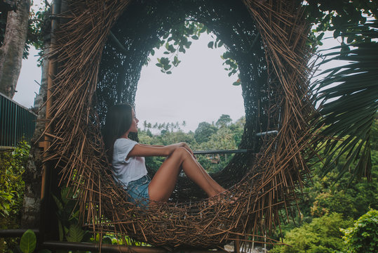 Beautiful girl having fun at the waterfalls in Bali. Concept about wanderlust traveling and wilderness culture