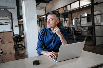 Adult attractive man boss director in office looking concentrated and busy. Successful business strategy plan concept. Confident office worker indoor in coworking space. People lifestyle