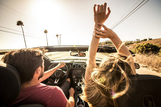 Couple driving on a convertible car